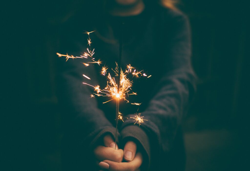 person holding a sparkler, pixabay