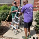 Georges and Walt carrying a ladder