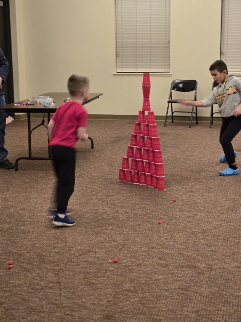 Kids making a big cup tower